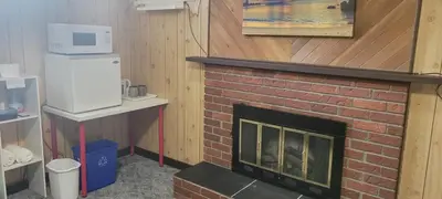 a brick fireplace with a microwave on top of it at WhiteCourt in Abbotsford