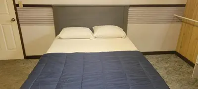 a bed with two pillows on it in a room at WhiteCourt in Abbotsford