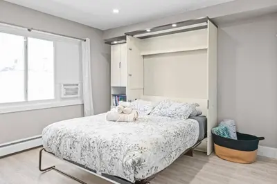 a bedroom with a bed with a teddy bear on it at Boutique-Style Studio Unit in Edmonton