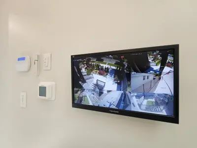 a flat screen tv hanging on a wall at Luxury 3-Bedroom Home Modern Retreat in Vancouver in Vancouver