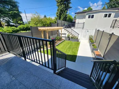 a balcony of a house with a yard at Luxury 3-Bedroom Home Modern Retreat in Vancouver in Vancouver