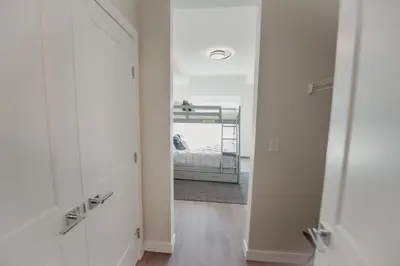 a hallway with a mirror and a bed in a room at New Vaulted Ceilings 3 Beds AC Views in Golden