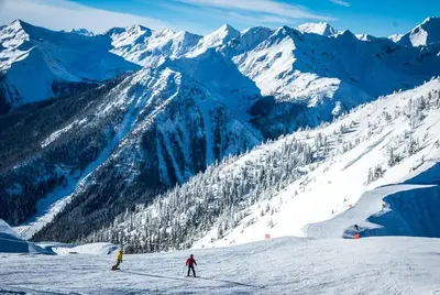 two people skiing down a snow covered mountain at New Vaulted Ceilings 3 Beds AC Views in Golden