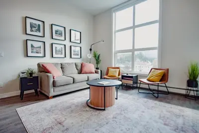 a living room with a couch and a table at New Vaulted Ceilings 3 Beds AC Views in Golden