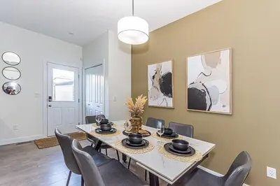 a dining room with a table and chairs at Escape in Style, River Cree, Netflix, Near WEM in Edmonton