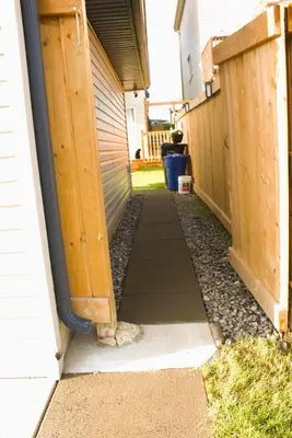 a walkway leading into a house with a fence at Entire Walkout Basement Suite 2 BDRM King & Queen Patio Prvt Entrance in Edmonton