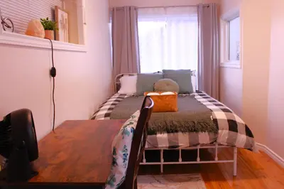 a small bedroom with a bed with a teddy bear on it at Entire Walkout Basement Suite 2 BDRM King & Queen Patio Prvt Entrance in Edmonton