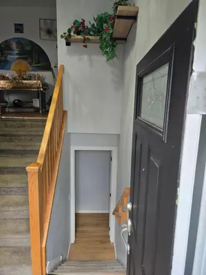a stairway with a black door and a hallway with stairs at Dream house in Edmonton