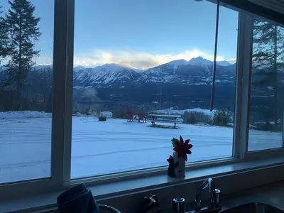 a window with a view of a snow covered field at Uncle Bills Cabin Entire home 6 min south of town in Golden