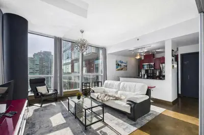 a living room with a couch and a table at Modern Beltline Escape Sky-High Views DT Views in Calgary