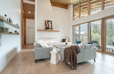 a living room with two couches and a table at Camozzi Chalet by Revelstoke Vacations in Revelstoke