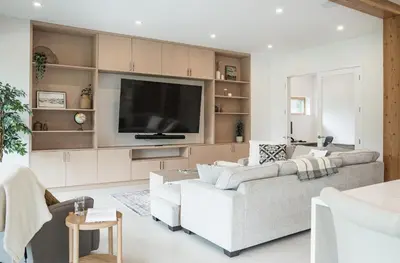 a living room with a couch and a tv at Camozzi Chalet by Revelstoke Vacations in Revelstoke
