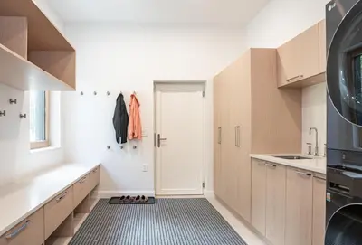 a kitchen with wooden cabinets and a door at Camozzi Chalet by Revelstoke Vacations in Revelstoke