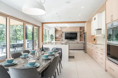 a kitchen and dining room with a table and chairs at Camozzi Chalet by Revelstoke Vacations in Revelstoke