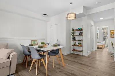 a dining room and living room with a table and chairs at Full Townhouse Cozy Guest Favorite Garage Parking Aspen Neighbourhood in Calgary