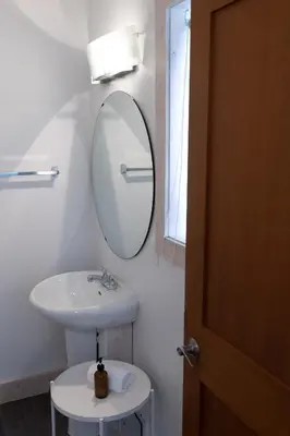 a bathroom with a sink and a mirror at Fieldstone Guesthouse in Clearwater