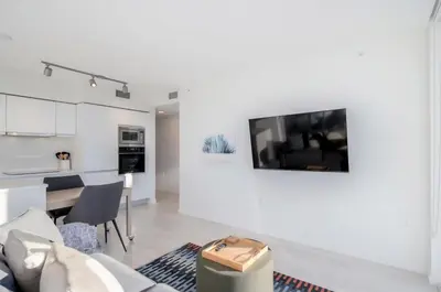 a living room with a tv on a white wall at Peaceful City Stay, Calm Vibes in a Cozy in Vancouver