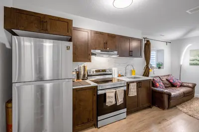 a kitchen with wooden cabinets and a stainless steel refrigerator at New 2BD Suite Near Events Center in Langley