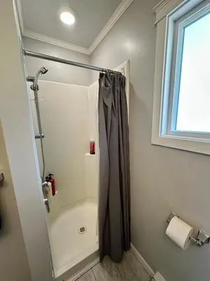 a bathroom with a shower with a shower curtain at Beautiful home near City centre! in Kitimat