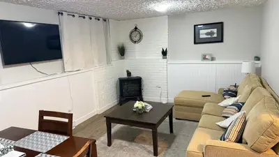 a living room with a couch and a tv at Supinder's Rentals in Golden