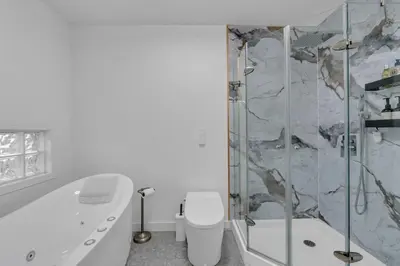a bathroom with a shower and a toilet and a tub at 1P Culture - Sara in Calgary