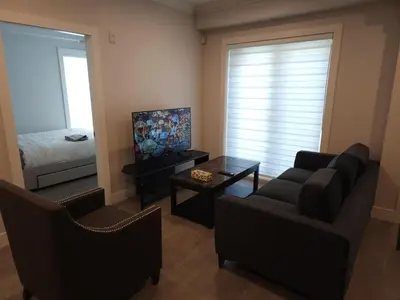 a living room with a couch and a bed at Central 2-Bedroom Townhouse Oak st in Vancouver