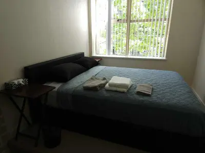 a bedroom with a bed with two towels on it at Central Townhouse Richards Street in Vancouver