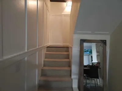 a staircase in a house with a hallway with a mirror at Central Townhouse Richards Street in Vancouver