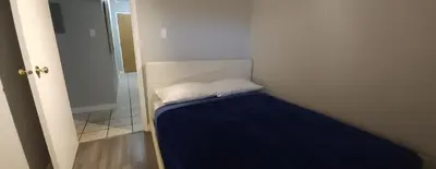 a small room with a bed with two pillows at YYC : 2-Bedroom City Apartment in Calgary