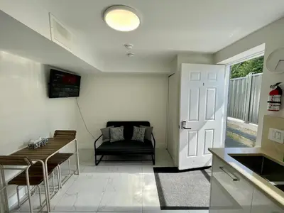 a kitchen and living room with a couch and a table at Budget friendly 2-Bed 1-Bath Suite in New Westminster