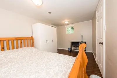 a bedroom with a bed and a fireplace at 4 Bedroom Semi-basement Suite in Burnaby Metrotown in Burnaby