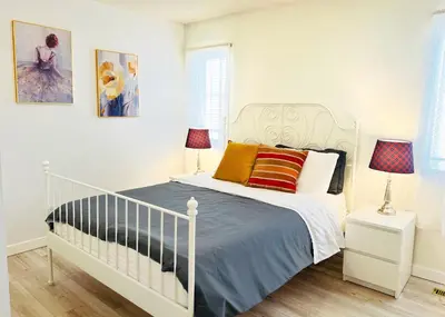 a bedroom with a white bed and two lamps at Entire 6BED house easy to Banff & DT, Winsport in Calgary