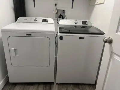 two white refrigerators sitting next to each other in a room at Entire 6BED house easy to Banff & DT, Winsport in Calgary