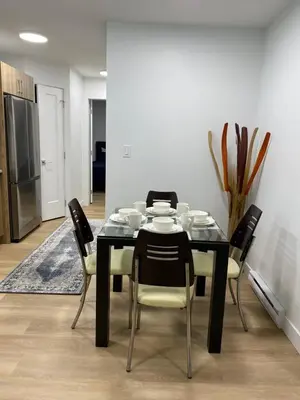 a dining room with a black table and chairs at Oceanside 2 Bedroom Suite in Royal Bay-Free Nespresso Coffee with Welcome Treats in Colwood