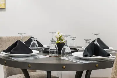 a table with plates and napkins on top of it at Lake Community Hideout in Chestermere