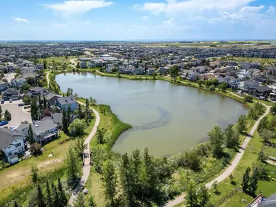 an aerial view of a town with a river at Lake Community Hideout in Chestermere