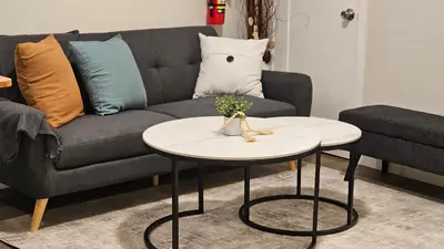 a living room with a couch and a table at Modern Suite - Separate Entry - Self Check-In in Calgary