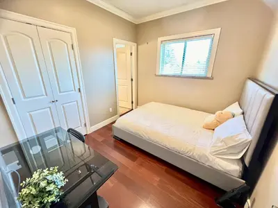 a small bedroom with a bed and a window at Cozy stay in Cental Vancouver in Vancouver
