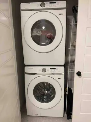 a washing machine and a dryer in a room at Bedroom with TV in Upland E in Edmonton