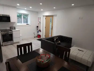 a living room with a couch and a table at vistaeast 1-Bedroom Condo Rupert st in Vancouver