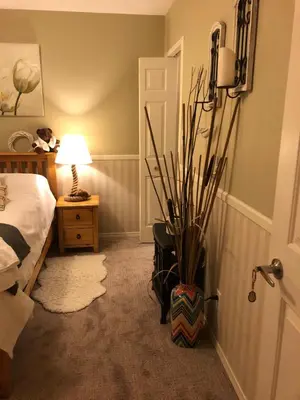 a bedroom with a bed and a potted plant at Country Cottage B&B in Vernon