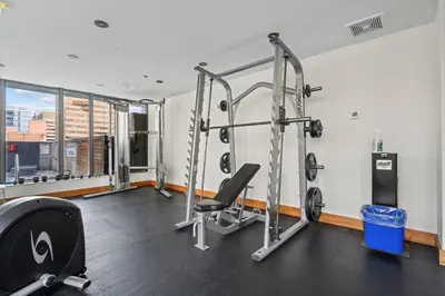 a fitness room with a gym with tread machines at Elegant, Comfy & Sophisticated MetroLux Downtown Suite in Calgary