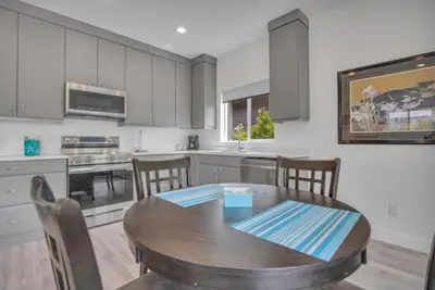 a kitchen with a table and chairs in a kitchen at Pure Paradise in Prince George