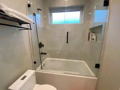 a bathroom with a shower and a tub and a toilet at \u6e29\u54e5\u534eubc\u5927\u5b66\u522b\u5885 in Vancouver