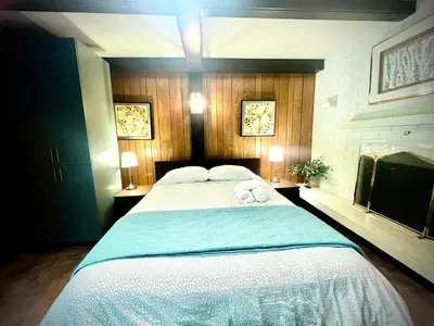 a bedroom with a large bed with two towels on it at Spacious place Close to UBC -1 in Vancouver