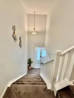 a stairway with white railings and a white staircase at Zillion’s Joy in Calgary