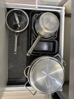 a drawer filled with pans and other kitchen utensils at Zillion’s Joy in Calgary