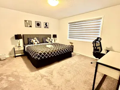 a bedroom with a bed and a window at Zillion’s Joy in Calgary