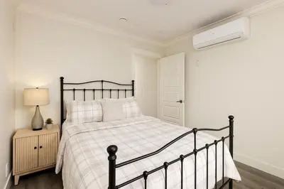 a bedroom with a bed with a black frame at Spacious 4BD Home in Vancouver in Vancouver