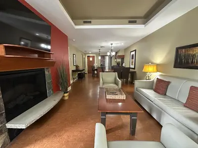 a living room with a couch and a fireplace at Solara 2BR Retreat - Pool - Hot Tub & Resort Perks in Canmore